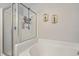 Bathroom featuring a tub with glass door and decorative artwork on the wall at 1717 Brittlebush Ln, Johns Island, SC 29455