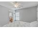 Bedroom showcasing soft gray walls, a ceiling fan, carpeted floors, and an adjacent bathroom at 1717 Brittlebush Ln, Johns Island, SC 29455