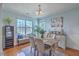 Bright dining room with modern chandelier, large window, and hardwood flooring at 1717 Brittlebush Ln, Johns Island, SC 29455