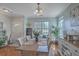 Spacious dining room featuring hardwood floors, stylish decor, and a view of the front yard at 1717 Brittlebush Ln, Johns Island, SC 29455