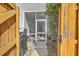 Inviting patio entrance with a screen door and a wooden gate to the outdoor living space at 1717 Brittlebush Ln, Johns Island, SC 29455