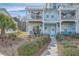 Charming coastal townhome featuring a private balcony and well-maintained landscaping with inviting walkway at 1717 Brittlebush Ln, Johns Island, SC 29455