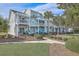 Coastal townhome with private balconies and well-manicured landscaping with grassy lawn at 1717 Brittlebush Ln, Johns Island, SC 29455