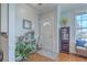 Inviting foyer with wood floors, decorative mirror and furnishings, and natural light at 1717 Brittlebush Ln, Johns Island, SC 29455