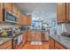 Modern kitchen with granite countertops, stainless steel appliances, and hardwood floors at 1717 Brittlebush Ln, Johns Island, SC 29455