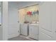 Convenient laundry room with modern washer and dryer units and ample shelving for storage at 1717 Brittlebush Ln, Johns Island, SC 29455