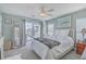 Bright main bedroom with a ceiling fan, private balcony access, and comfortable decor at 1717 Brittlebush Ln, Johns Island, SC 29455