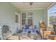 Relaxing screened porch with comfortable seating, stylish decor, and natural light at 1717 Brittlebush Ln, Johns Island, SC 29455