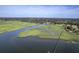 Beautiful aerial view of a waterfront property boasting a private pier extending into tranquil marsh waters at 185 Wappoo Rd, Charleston, SC 29407