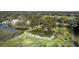 An aerial view displays the homes nestled amidst verdant trees and next to a tranquil pond at 185 Wappoo Rd, Charleston, SC 29407