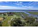 Striking aerial view of waterfront property with lush green landscape, complemented by serene water views and clear blue sky at 185 Wappoo Rd, Charleston, SC 29407