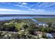 Breathtaking aerial view of waterfront property with lush landscape, serene water views and mature trees on a clear day at 185 Wappoo Rd, Charleston, SC 29407