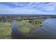Waterfront property aerial view with private pier and views of lush marshland and serene waterways at 185 Wappoo Rd, Charleston, SC 29407