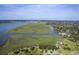 Stunning aerial view of waterfront property with expansive marsh views and a charming red-roofed house at 185 Wappoo Rd, Charleston, SC 29407