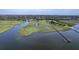 Aerial perspective of waterfront property featuring a private pier, marshland, and serene coastal views at 185 Wappoo Rd, Charleston, SC 29407