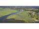 Picturesque aerial shot showcasing waterfront property with a long pier extending into the serene marshland at 185 Wappoo Rd, Charleston, SC 29407