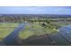 Breathtaking aerial view of waterfront home featuring a private pier leading to the tranquil waters at 185 Wappoo Rd, Charleston, SC 29407