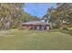 Charming one-story brick home surrounded by mature trees and a well-maintained lawn at 185 Wappoo Rd, Charleston, SC 29407