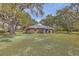 Quaint single-story home on a well-manicured lawn, surrounded by mature trees offering ample shade at 185 Wappoo Rd, Charleston, SC 29407