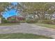 Charming brick home with well-maintained front yard and mature trees offering ample shade at 185 Wappoo Rd, Charleston, SC 29407