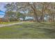 Charming home nestled among mature trees, surrounded by lush green lawn at 185 Wappoo Rd, Charleston, SC 29407