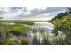 Scenic marsh view featuring serene water, lush green vegetation, and blue skies at 185 Wappoo Rd, Charleston, SC 29407