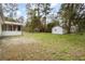 Backyard view of home featuring a white brick exterior and green lawn at 201 Hayden St St, Walterboro, SC 29488