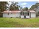 The house features a large backyard with a white picket porch and a red metal roof at 201 Hayden St St, Walterboro, SC 29488