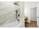 The bathroom has a white bathtub with shower, modern tile and black fixtures at 201 Hayden St St, Walterboro, SC 29488