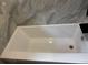 Clean, white bathtub with tile surround and black fixture at 201 Hayden St St, Walterboro, SC 29488