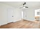 Spacious bedroom with wood floors, a ceiling fan, and access to the bathroom at 201 Hayden St St, Walterboro, SC 29488