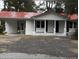 Charming one-story home featuring a red metal roof, white painted brick, and a convenient carport at 201 Hayden St St, Walterboro, SC 29488