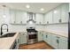 New kitchen featuring stainless steel appliances and light green custom cabinetry at 201 Hayden St St, Walterboro, SC 29488