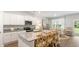 Open-concept kitchen with stainless steel appliances, stone countertops, and a connected dining area at 2234 Macallan Blvd, Ravenel, SC 29470