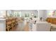 Open-concept living space featuring the kitchen, dining room, and living room with natural light at 2234 Macallan Blvd, Ravenel, SC 29470