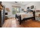 Sunlit bedroom with hardwood floors, a striking dark wood bed, and bright window at 2244 Ashley Crossing Dr # 426, Charleston, SC 29414