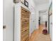Hallway view featuring a wooden cabinet, doors to other rooms, and wood floors at 2244 Ashley Crossing Dr # 426, Charleston, SC 29414