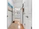 Hallway view of the bathroom featuring white painted walls, wood floors, and white cabinets at 2244 Ashley Crossing Dr # 426, Charleston, SC 29414