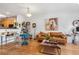 Bright living room features hardwood floors, a tan leather sofa, and an open floor plan at 2244 Ashley Crossing Dr # 426, Charleston, SC 29414