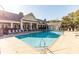 Large community swimming pool with ample lounge chairs and clubhouse in the background at 2244 Ashley Crossing Dr # 426, Charleston, SC 29414