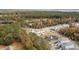 An aerial view of homes nestled within a lush community, featuring a tranquil pond with fountains and abundant trees at 2280 Minfarm Way # 529, Mount Pleasant, SC 29466