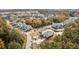An aerial view of charming homes nestled within a lush community, featuring a tranquil pond and vibrant fall foliage at 2280 Minfarm Way # 529, Mount Pleasant, SC 29466