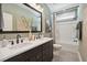 Well-lit bathroom with double sinks, framed mirror, and bathtub with a shower for convenience at 2280 Minfarm Way # 529, Mount Pleasant, SC 29466