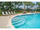 Zero entry community pool with lounge chairs, striped umbrellas, and lush landscaping at 2280 Minfarm Way # 529, Mount Pleasant, SC 29466