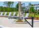 Poolside basketball hoop and lounge chairs next to the pool and well maintained landscaping at 2280 Minfarm Way # 529, Mount Pleasant, SC 29466