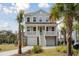 Charming two-story home with a double garage and a inviting front porch, surrounded by lush greenery and palm trees at 2280 Minfarm Way # 529, Mount Pleasant, SC 29466