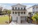 Inviting two-story home features a double garage and a charming front porch, perfect for relaxing and enjoying the neighborhood at 2280 Minfarm Way # 529, Mount Pleasant, SC 29466