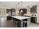 Modern kitchen with a large island, dark cabinets, stainless steel appliances, and elegant pendant lighting at 2280 Minfarm Way # 529, Mount Pleasant, SC 29466