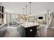 Open-concept kitchen with a central island, pendant lighting, and seamless flow to the dining and living spaces at 2280 Minfarm Way # 529, Mount Pleasant, SC 29466