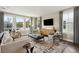 Bright living room with large windows, a comfortable seating area, and a stylish entertainment center at 2280 Minfarm Way # 529, Mount Pleasant, SC 29466